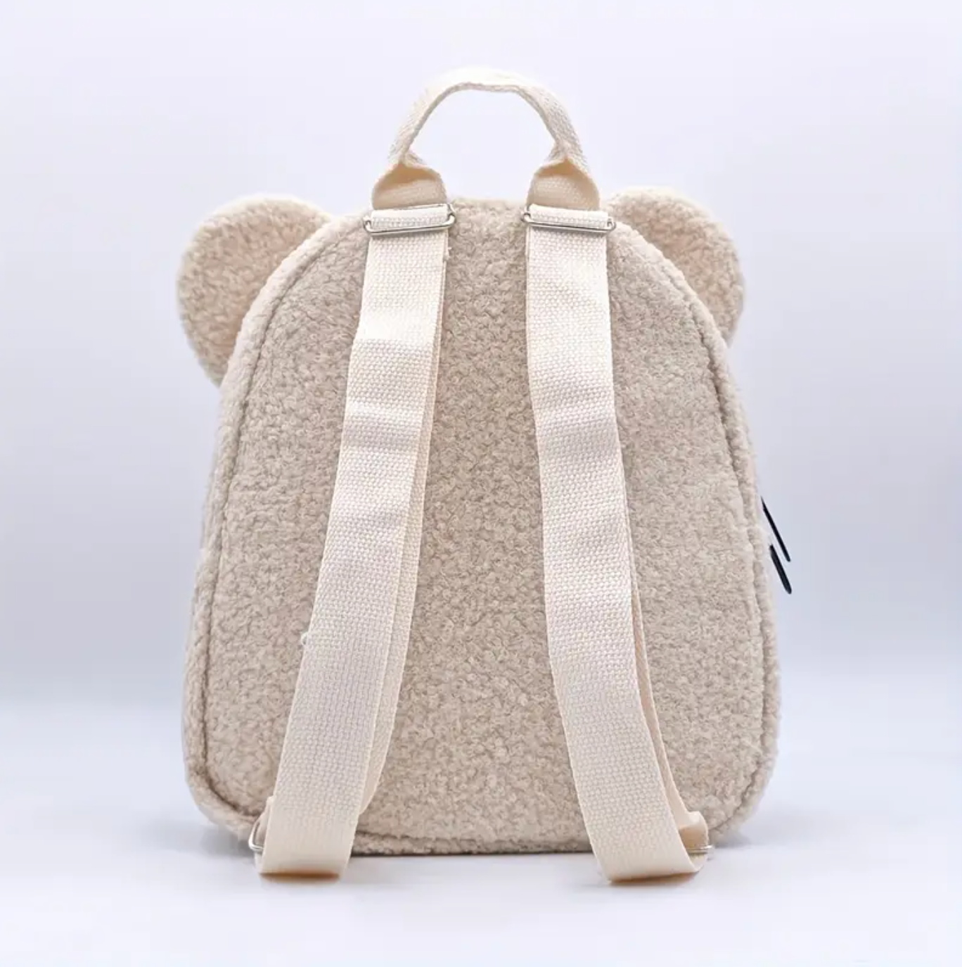 Cream straps of teddy bear backpack